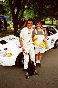 Érik Comas and a fan in front of the Mitsubishi Lancer Evo IV he and Julian Masters shared for the event.