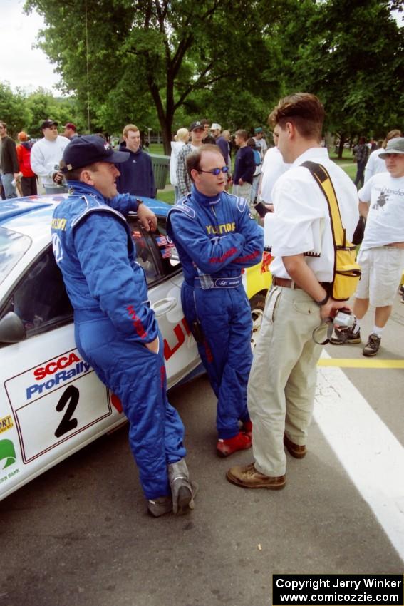 Noel Lawler and Charles Bradley are interviewed by Jeff Burmeister in front of their Hyundai Tiburon before the rally.