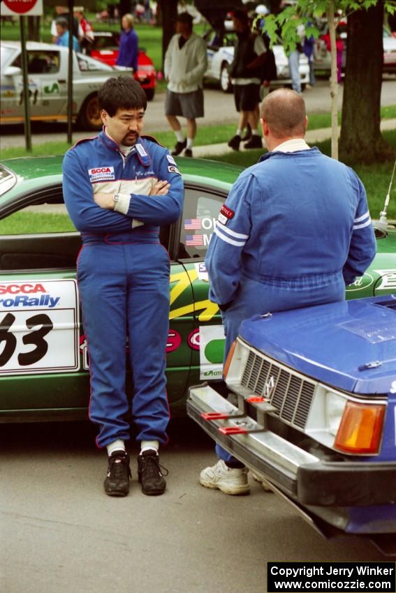 Tad Ohtake and Mark Utecht converse at parc expose before the rally.