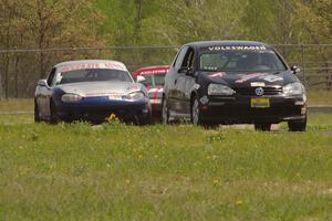 Tom Daly's T4 VW Rabbit ahead of Chris Craft's and Lon Blaser's Spec Miata Mazda Miatas