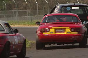 Tom Daly's T4 VW Rabbit ahead of Greg Youngdahl's and Lon Blaser's Spec Miata Mazda Miatas