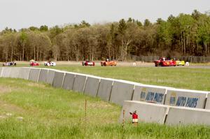 Spec Racer Fords dive into turn three on the second lap