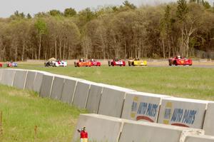 Spec Racer Fords dive into turn three on the second lap