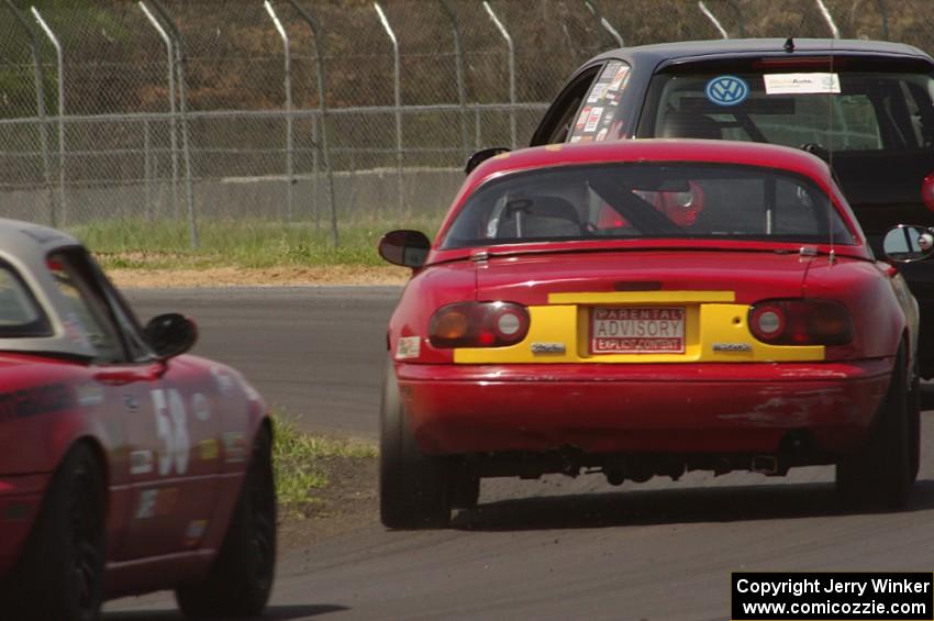 Tom Daly's T4 VW Rabbit ahead of Greg Youngdahl's and Lon Blaser's Spec Miata Mazda Miatas