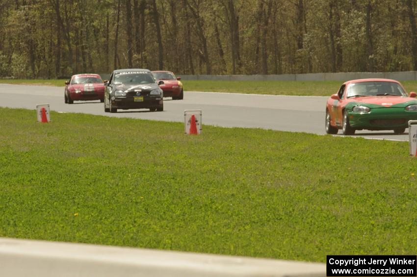 Four cars come into turn 4.