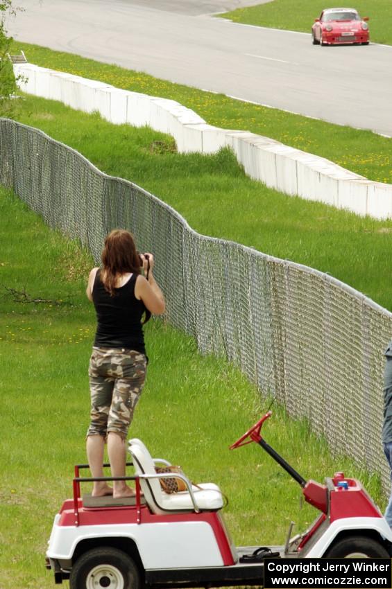 Shannon Ivey's Porsche 911SC is photographed by a spectator while headed into turn 1.