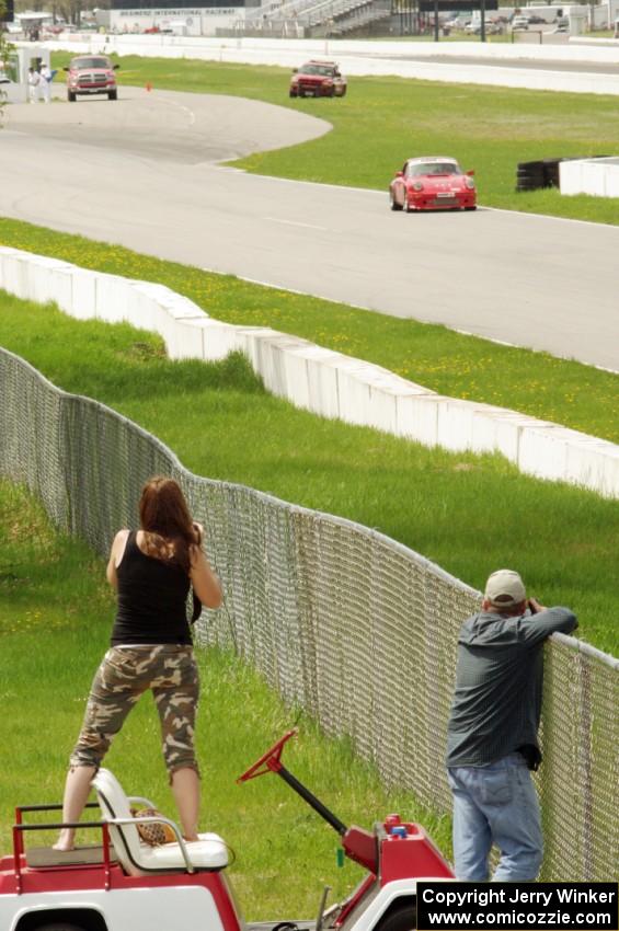 Shannon Ivey's Porsche 911SC is photographed by a spectator while headed into turn 1.