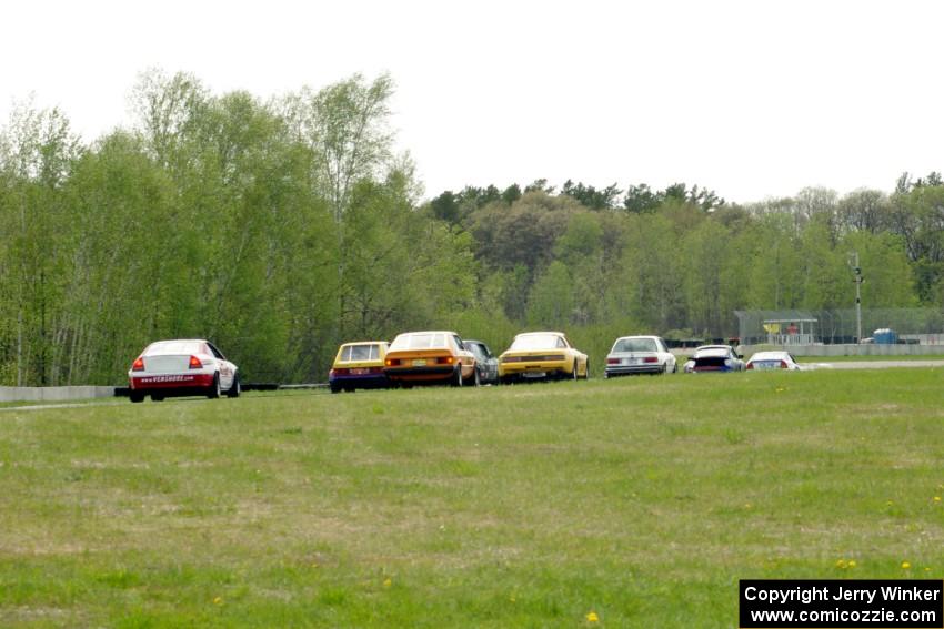 Race group 5 (small prods, GTs and IT cars) head down to turn 7 on the pace lap.