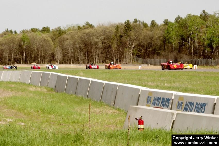 Spec Racer Fords dive into turn three on the second lap