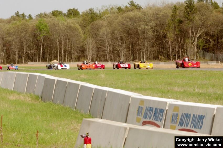 Spec Racer Fords dive into turn three on the second lap