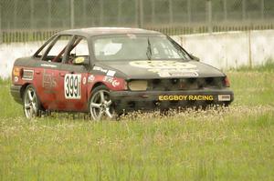 Eggboy Racing Ford Taurus SHO goes off onto the grass at turn 12.