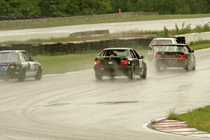 Four cars come out of turn 13 onto the front straight.