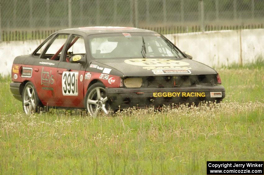 Eggboy Racing Ford Taurus SHO goes off onto the grass at turn 12.