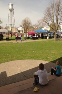 Enjoying a hot dog in town square with the car show going on.