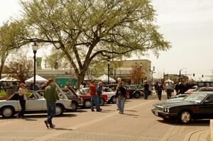 Various Mecedes-Benzs and Jaguars in front of the town square of Osseo