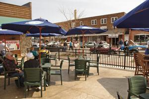 An outdoor patio makes for a wonderful view of the car show.