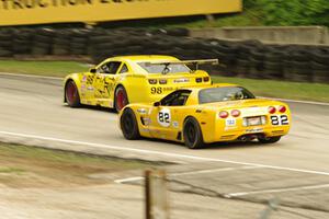 Bob Stretch's Chevy Camaro passes Norman Betts' Chevy Corvette