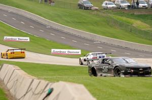 Tony Ave's Chevy Corvette and Cliff Ebben's Ford Mustang head uphill on the front straight