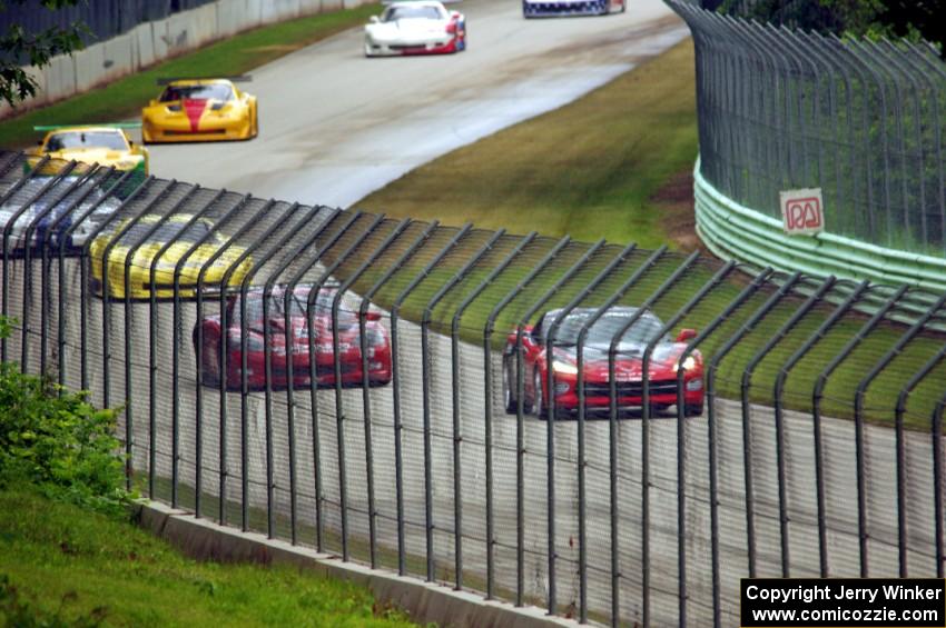 The field follows the pace car into turn 12