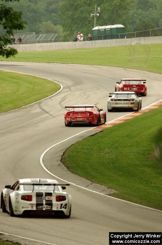Cameron Lawrence's and Adam Andretti's Chevy Camaros followed by Ron Keith's and Joe Ebben's Ford Mustangs