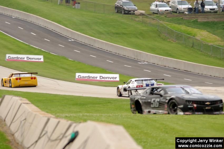 Tony Ave's Chevy Corvette and Cliff Ebben's Ford Mustang head uphill on the front straight