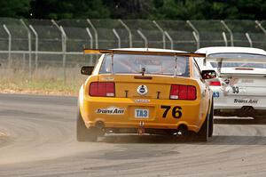 Chuck Cassaro's Ford Mustang chases down Jerry Greene's Porsche GT3 Cup