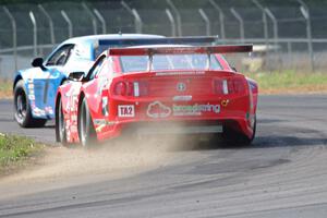 Ron Keith's Ford Mustang chases Cameron Lawrence's Dodge Challenger