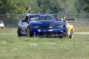 Fernando Seferlis' Chevy Camaro is chased by Chuck Cassaro's Ford Mustang