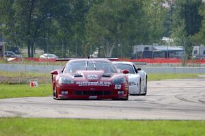 Amy Ruman's Chevy Corvette is chased by Cliff Ebben's Ford Mustang