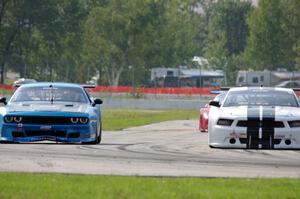 Joe Ebben's Ford Mustang and Cameron Lawrence's Dodge Challenger battle into turn 12.