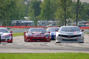 Amy Ruman's Chevy Corvette and Cliff Ebben's Ford Mustang weave through traffic