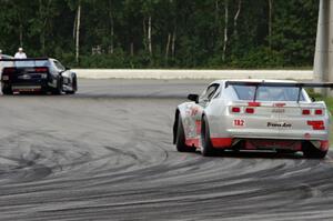 Jed Copham tries to catch Kevin Poitras, both in Chevy Camaros.