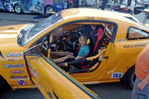 A young fan seated in Chuck Cassaro's Ford Mustang.