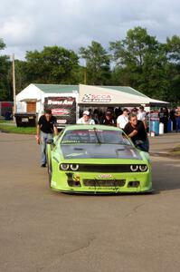 Tommy Kendall's Dodge Challenger is pushed through the paddock after the race.