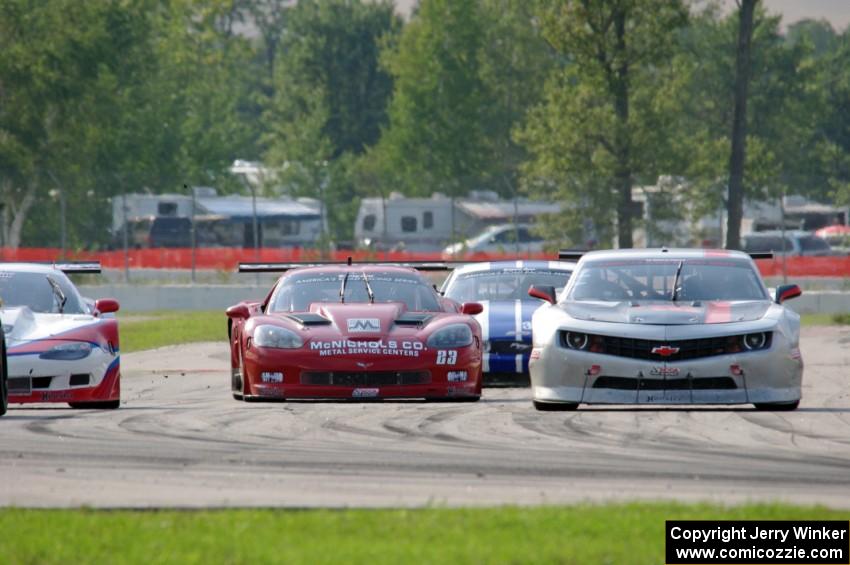 Amy Ruman's Chevy Corvette and Cliff Ebben's Ford Mustang weave through traffic