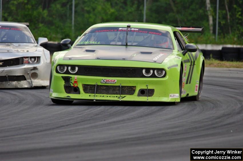 Tommy Kendall's Dodge Challenger holds of Adam Andretti's Chevy Camaro on the final lap of the race