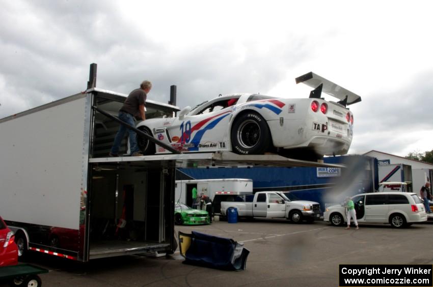 Kerry Hitt's Chevy Corvette is loaded back into the trailer.