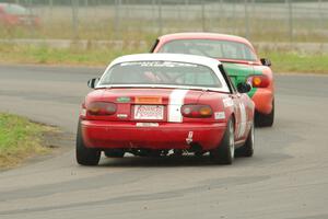 Erik Nelson's Spec Miata Mazda Miata ahead of Dan Schaut's STL Mazda Miata