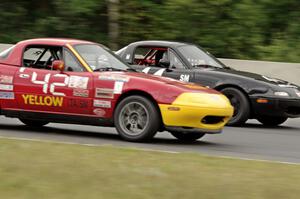 Greg Youngdahl's Spec Miata Mazda Miata passes Paul Gilbert's Spec Miata Mazda Miata