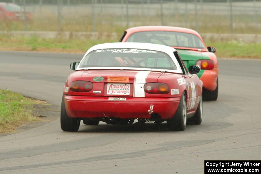 Erik Nelson's Spec Miata Mazda Miata ahead of Dan Schaut's STL Mazda Miata