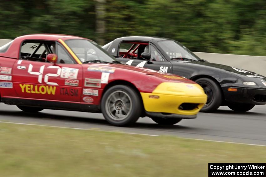 Greg Youngdahl's Spec Miata Mazda Miata passes Paul Gilbert's Spec Miata Mazda Miata