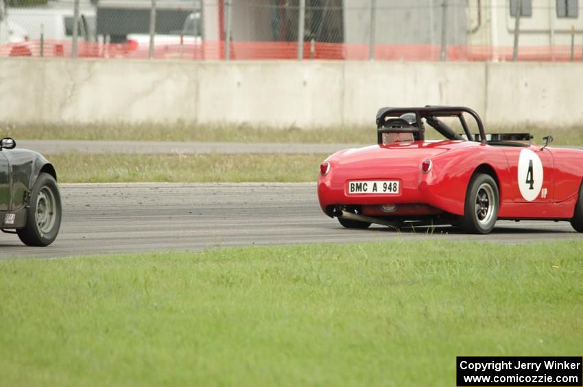 Tom Daly's Austin-Healey Sprite leads Phil Schaefer's Austin-Healey Sprite through the carousel.