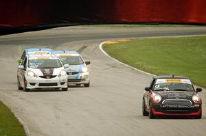 Glenn Nixon's MINI Cooper followed by Ryan Reed's Honda Fix, P.J. Groenke's Honda Fit and