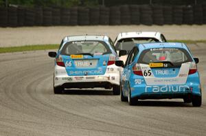 Ryan Reed's Honda Fix leads P.J. Groenke's Honda Fit and Paul Holton's Honda Fix