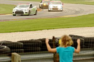 Jason Wolfe's Kia Forte Koup, Shea Holbrook's Honda Civic Si and Jason Cherry's Mazda MX-5 on the final lap.