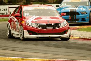 Mark Wilkins' Kia Optima and Tony Buffomante's Ford Mustang Boss 302S