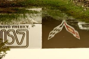 The Corvette Bridge reflected in a puddle at turn 6.