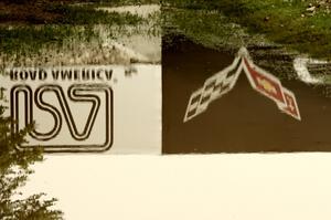 The Corvette Bridge reflected in a puddle at turn 6.