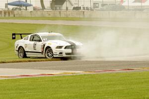 Chris Outzen's Ford Mustang Boss 302S comes to a stop after losing the engine on the first lap.