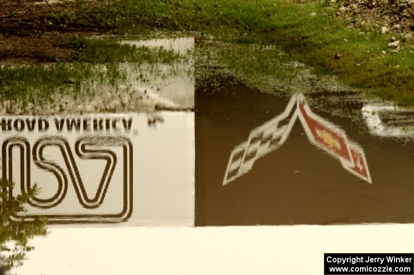 The Corvette Bridge reflected in a puddle at turn 6.